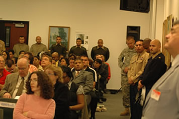 Marines and Army line the walls at the Board Meeting.